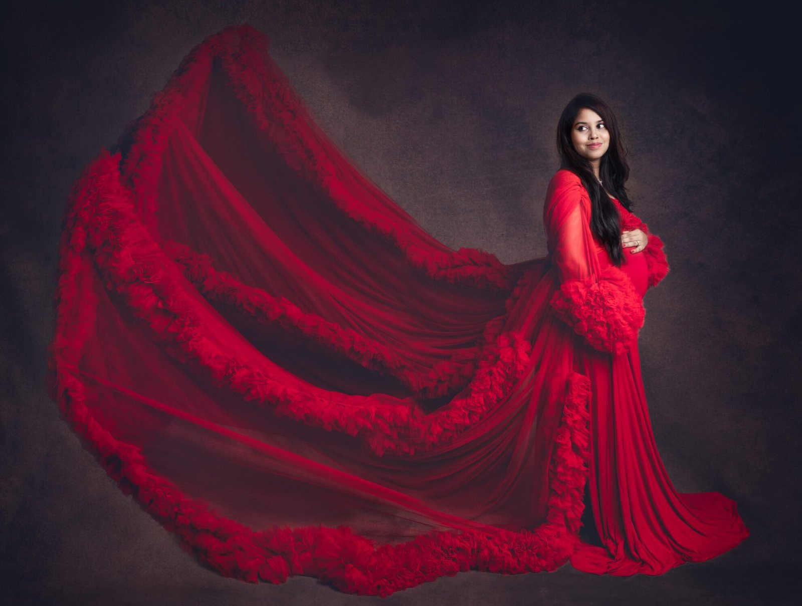 maternity pose in red gown